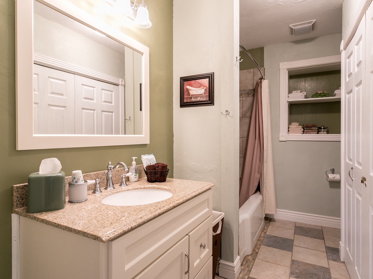 Full bathroom just off of the hallway includes a walk-in shower and beautiful tilework