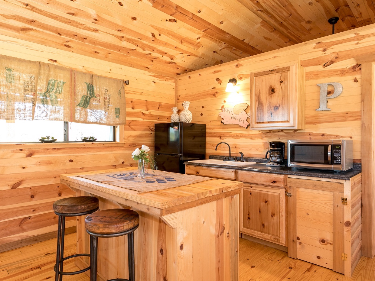 Well-equipped kitchen includes a large refrigerator, microwave, and coffeemaker