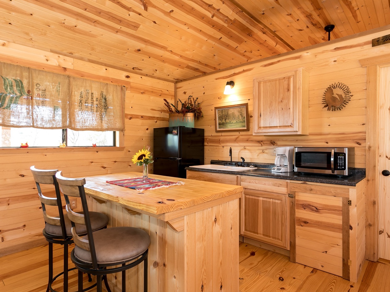 Nicely-equipped kitchen featuring a refrigerator, microwave, and coffeemaker