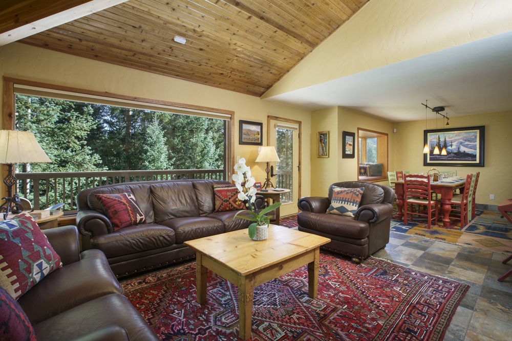 View into the living room with gas fireplace and flat screen television.