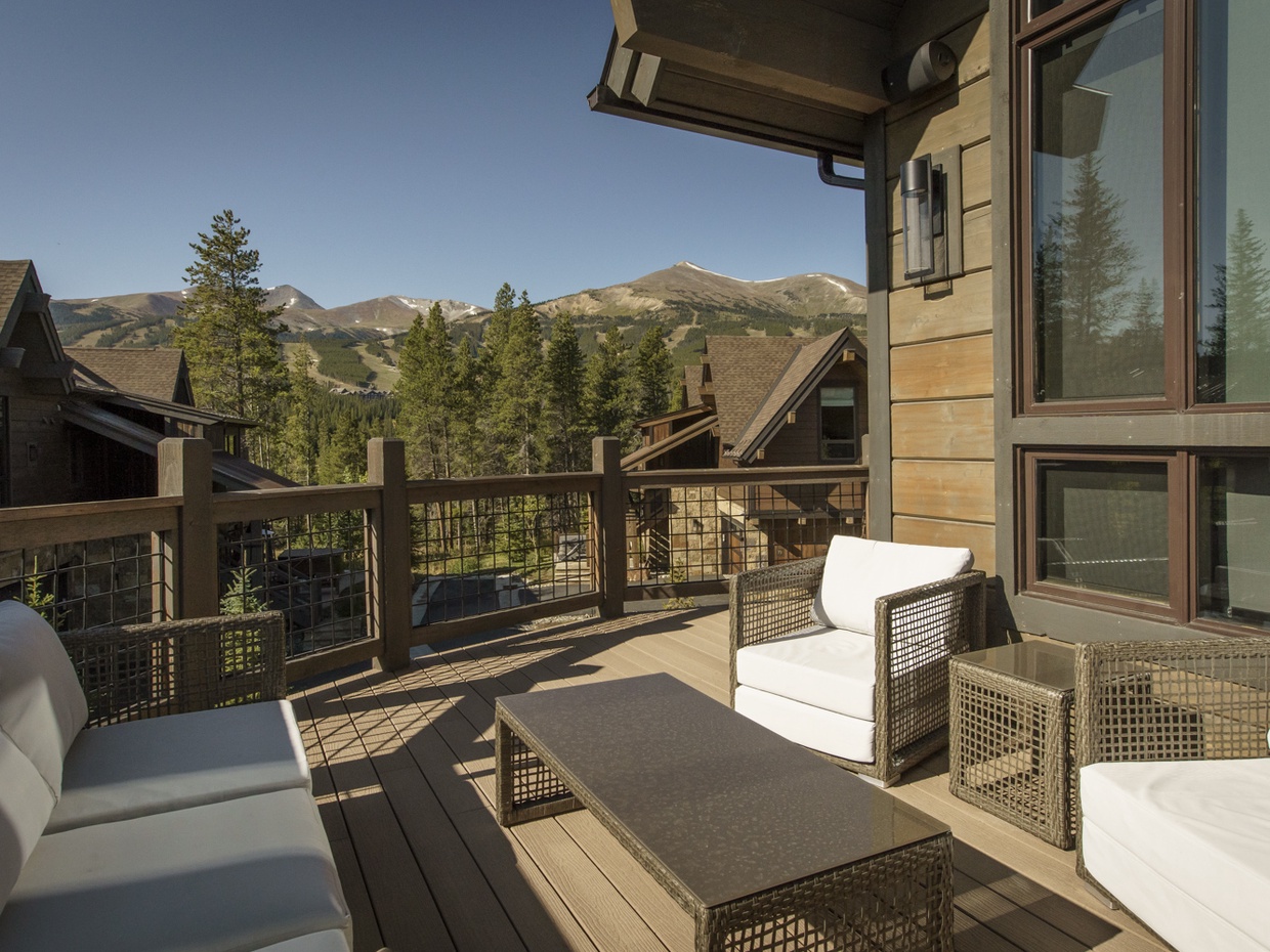 View from the main level balcony with outdoor lounging furniture and gas grill.