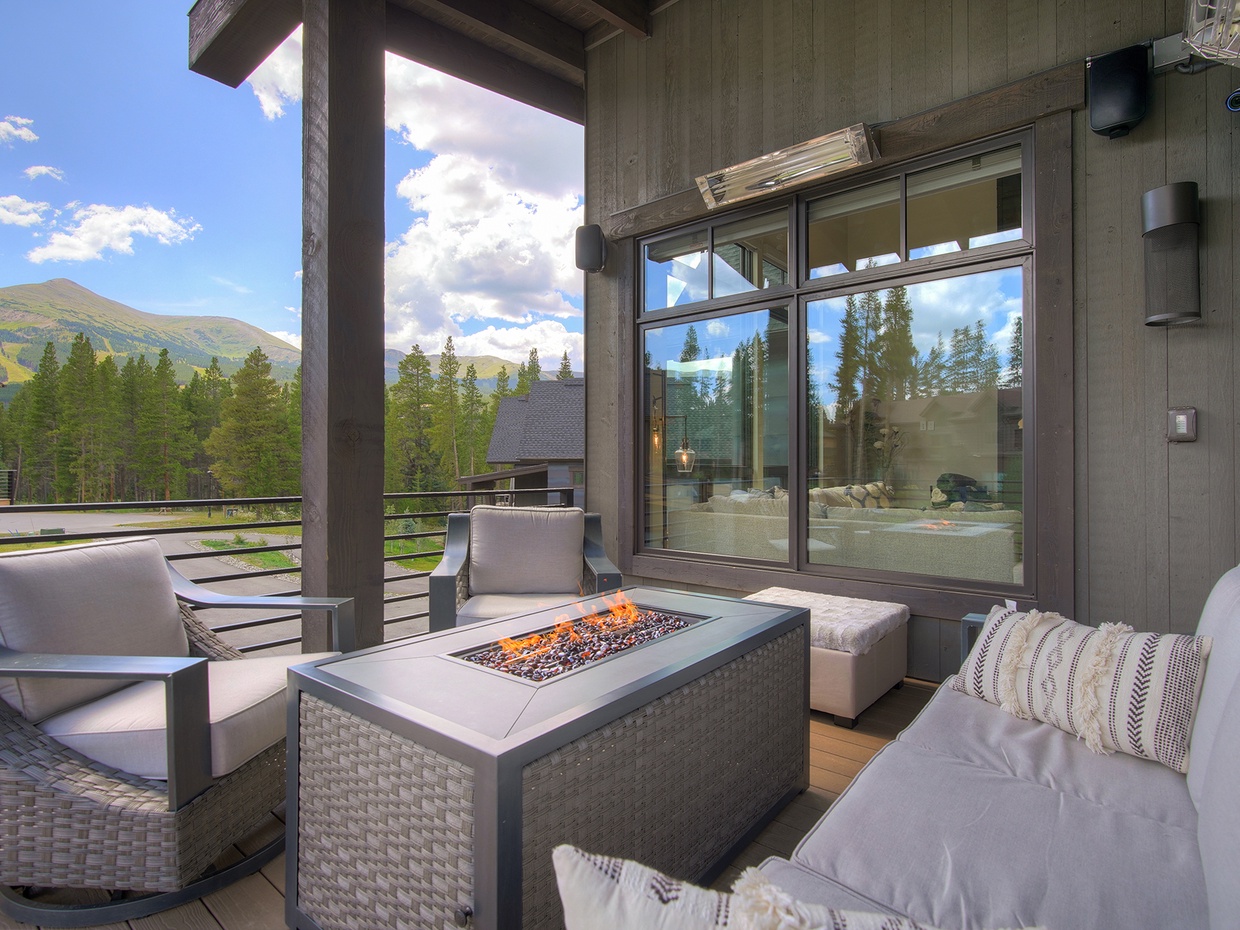 Upper-level patio off of the dinning room features a fireplace, gas grill, and room for up to eights guests.