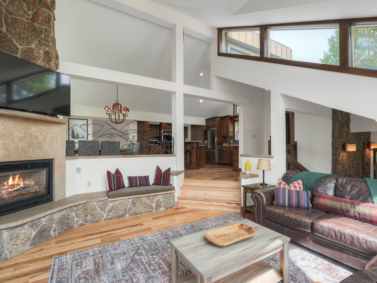 Level 4 (top): Living Room with comfortable couches, gas fireplace, and TV