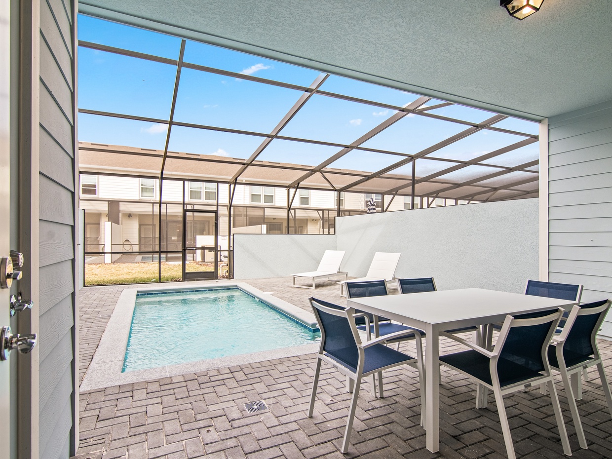 Private lanai with dining table, loungers & 1/2 bath