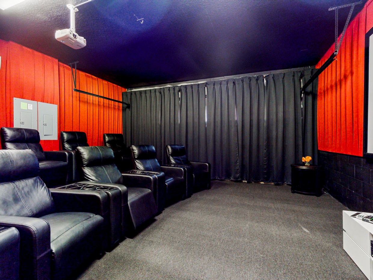 Movie Theater Room in converted garage with AC, big screen & DVD collection