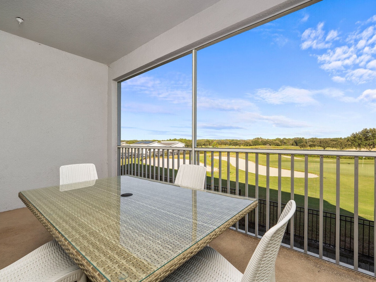 Enjoy your morning coffee on the balcony with stunning golf course views at Champions Gate Resort.