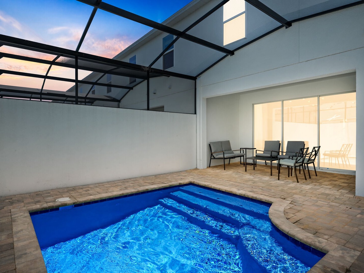 Unwind by the private pool at night in your cozy outdoor living room.
