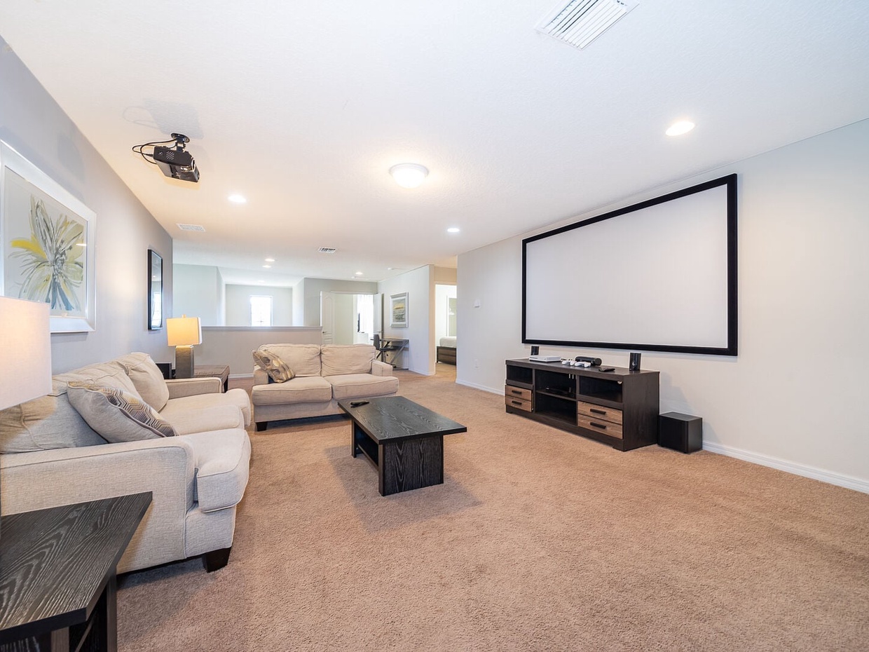 Gather the whole family for a cozy movie night in our spacious TV room, complete with ample plush seating for everyone to relax and enjoy.