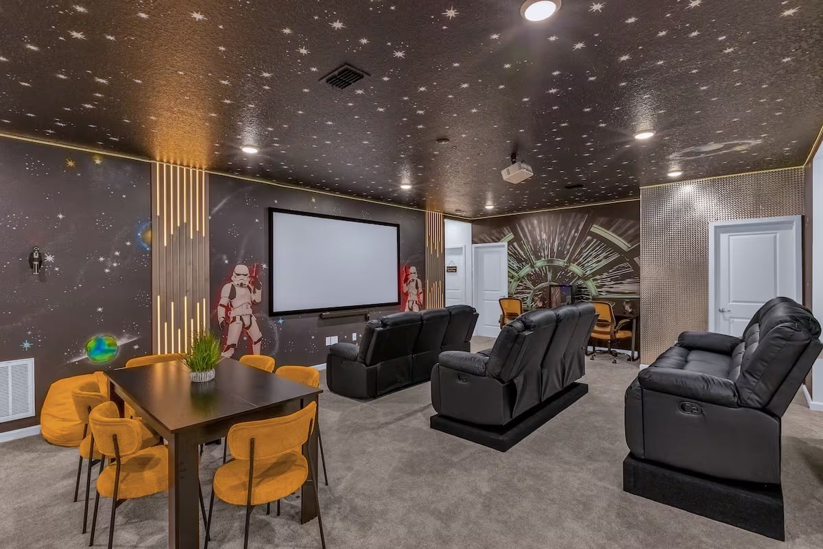 Settle in for movie nights in a dedicated cinema room featuring comfortable seating, a large screen, and an immersive entertainment experience.