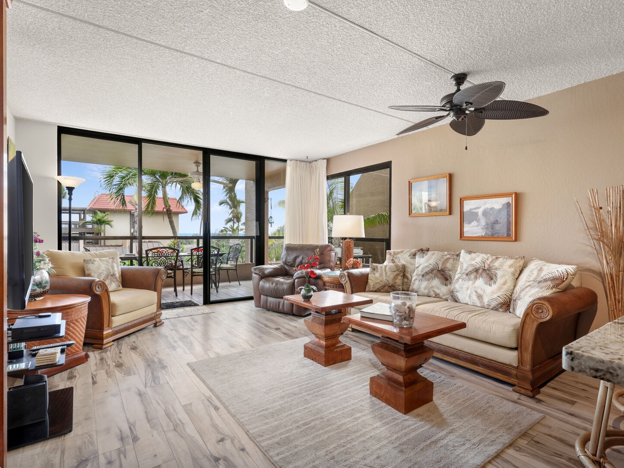Enjoy a spacious living room with AC. The open floor plan flowing from a large, well equiped kitchen onto the full width wrap-around lanai.