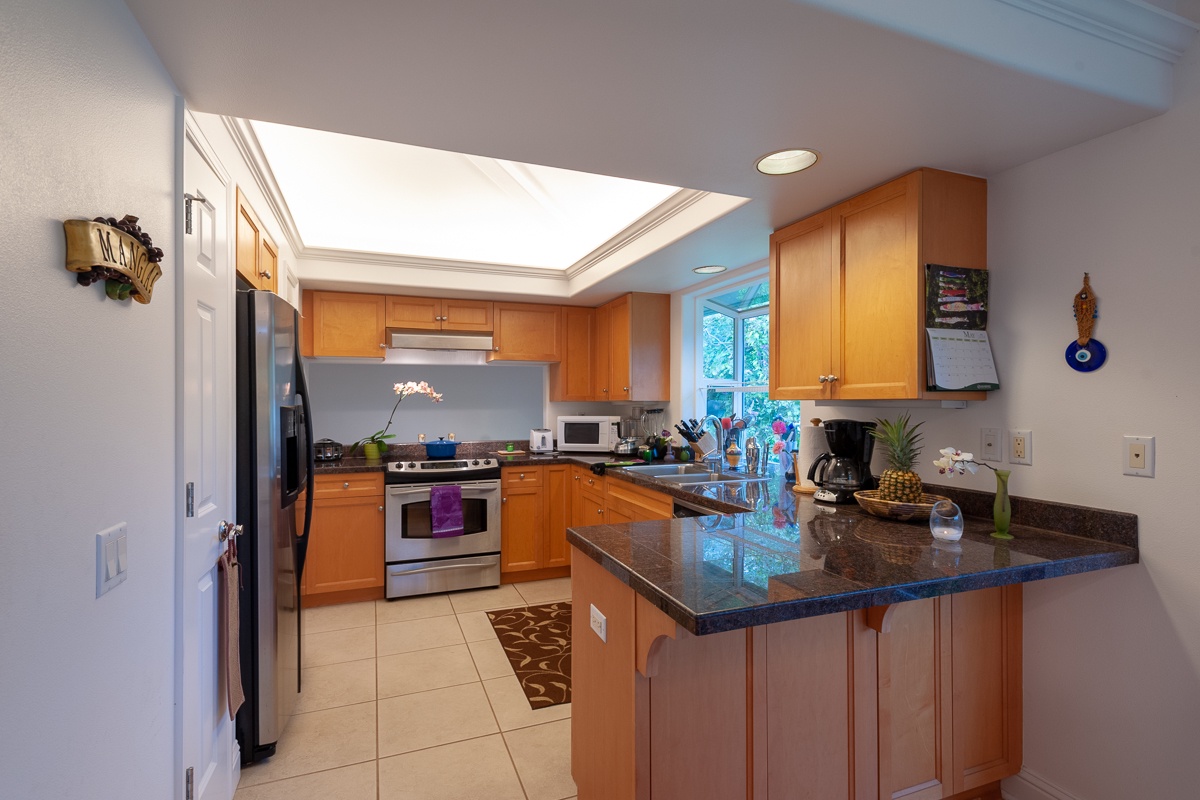 Behind the dining area you'll find a large, fully equipped kitchen with everything you might need to whip up your own meals.