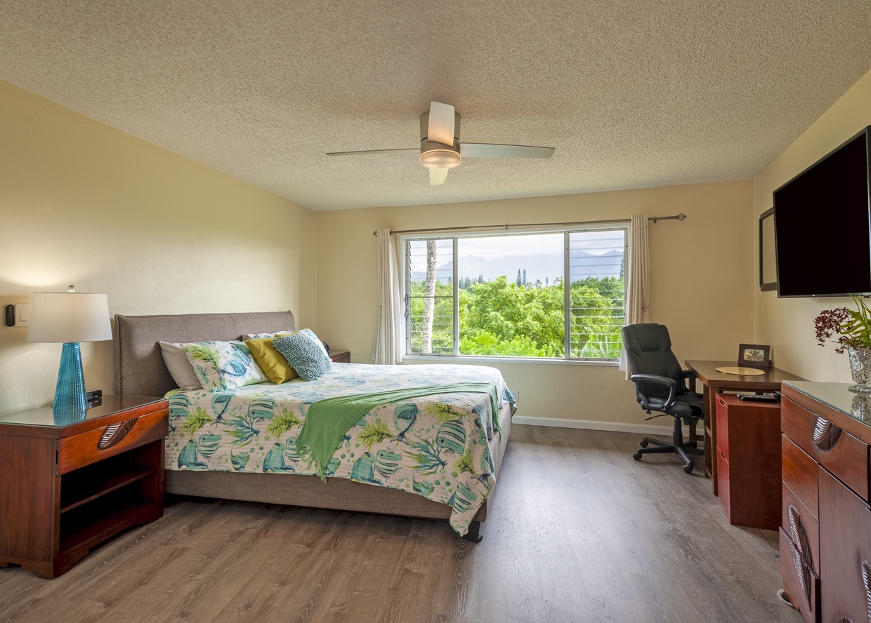 The master suite is a luxurious haven with a plush king sized bed and lush tropical views. 