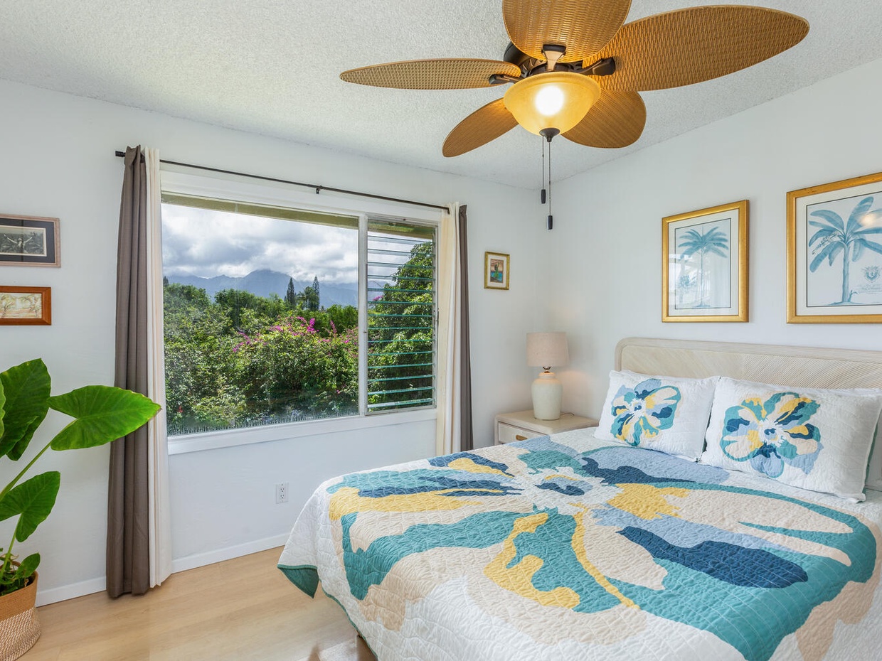 The second bedroom has incredible views of Kauai's mountainous interior, and features the same jalousie windows to keep breezes flowing through the whole house