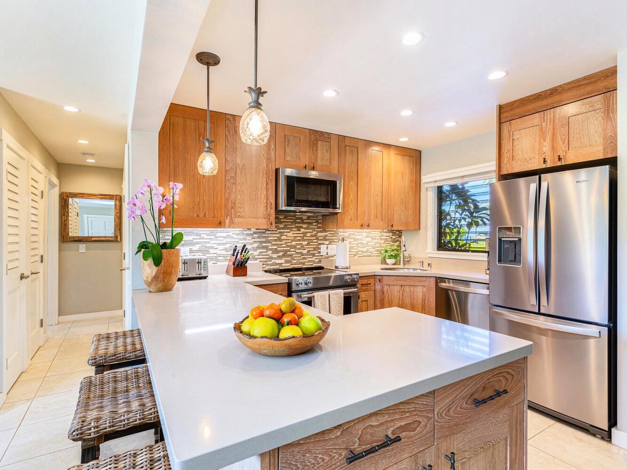 The updated, spacious kitchen has everything you might need for preparing any and every meal during your stay! With new stainless steel appliances, beautiful stone countertops, and a full stock of dishes and utensils, it's a home cook's dream.