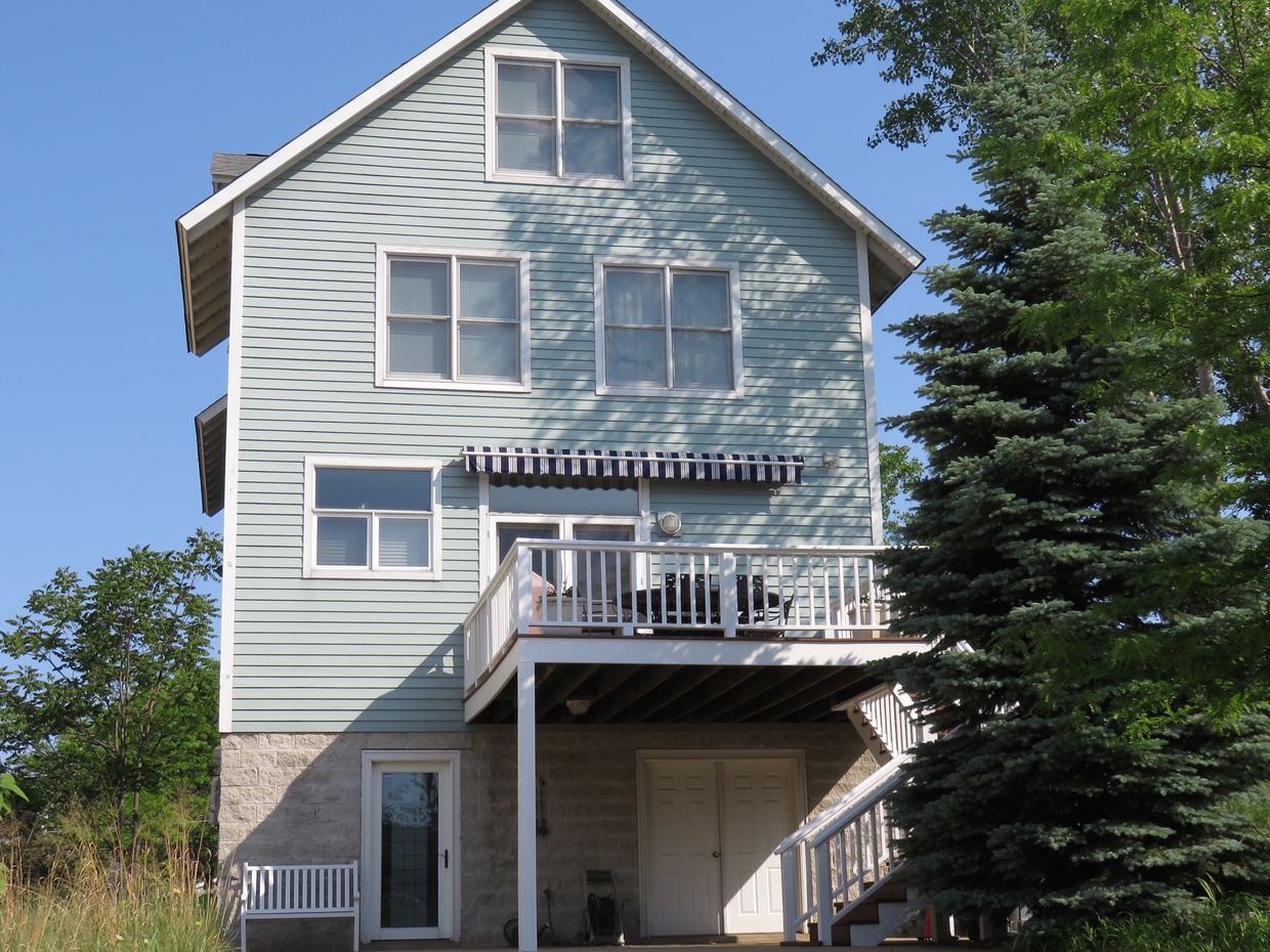Back of the home is where you access the house.  Ground level goes to laundry/mud room and the stairs go to the kitchen main living space.