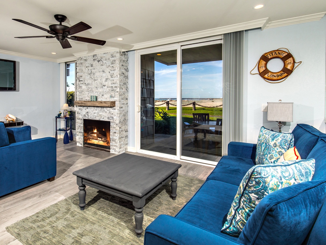 The living room is comfortably furnished with a queen sofa bed and comfortable chair.