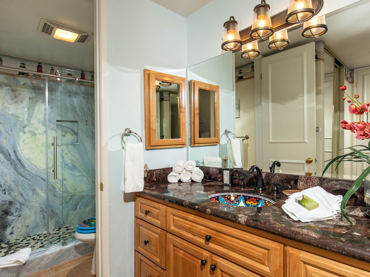 The bathroom features a tub/shower combination and a separate dressing area with granite counters.