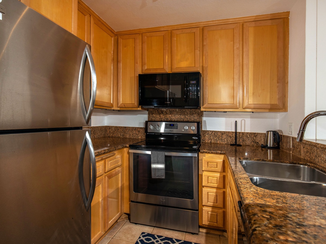 The kitchen features granite countertops and stainless appliances.