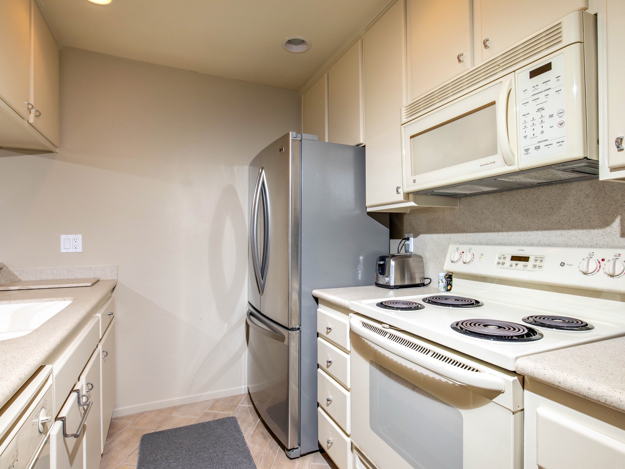 The kitchen is equipped with dishes, pots and pans, and cooking utensils.