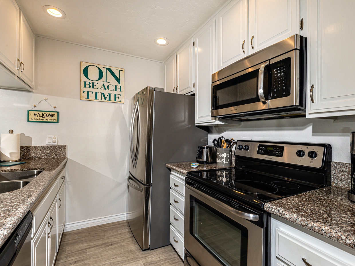 The chef's kitchen features stainless appliances, recessed lighting, a wood-look porcelain floor. 