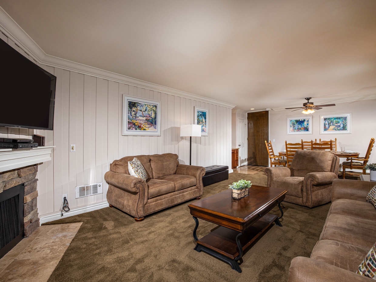 A beautiful stone fireplace enhances the living area.