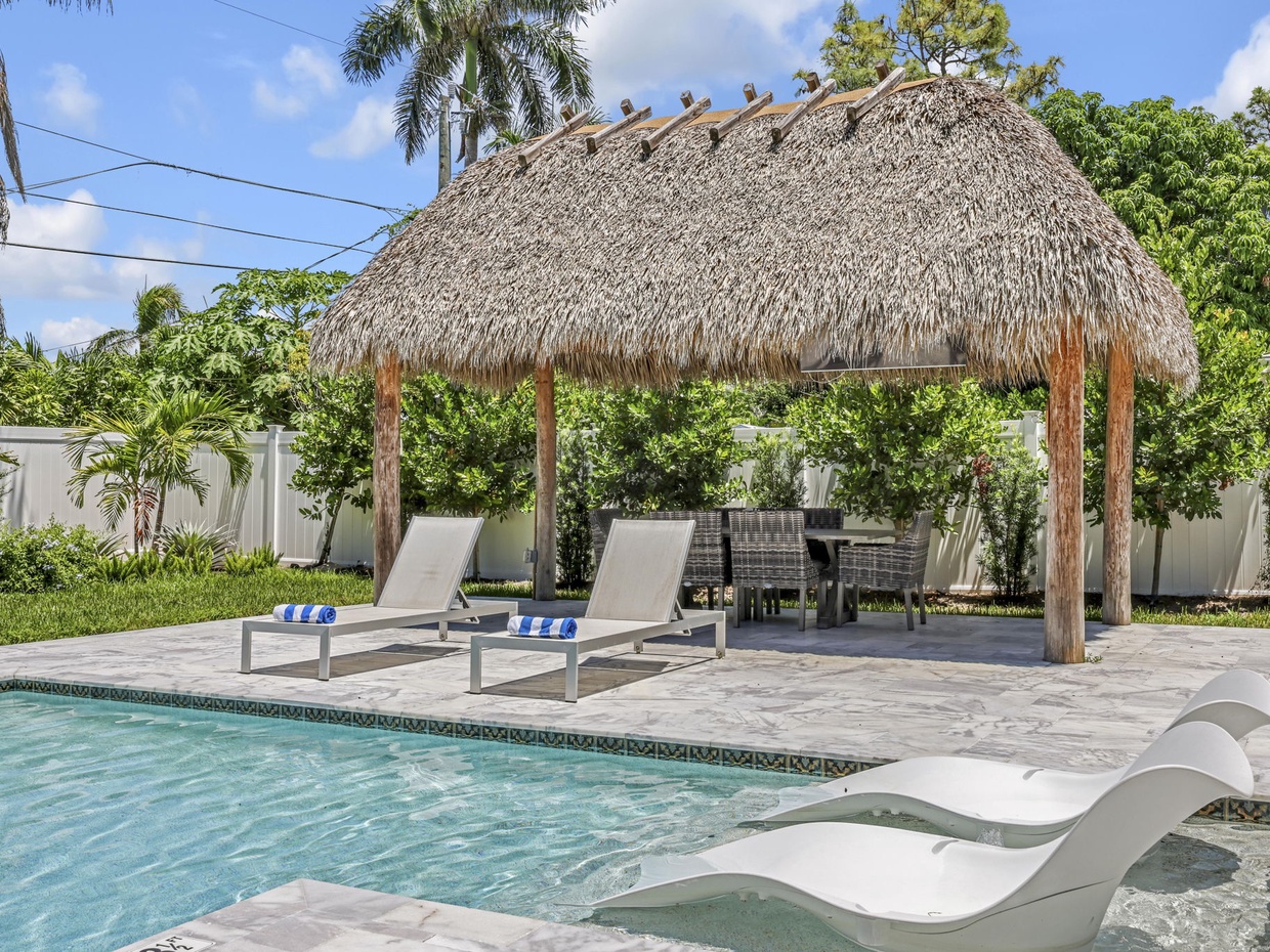 Custom tiki with seating for 6 and mounted Smart TV.