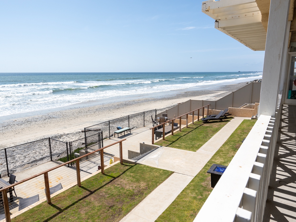 Oceanfront view of sandy beach and waves from upper-level balcon