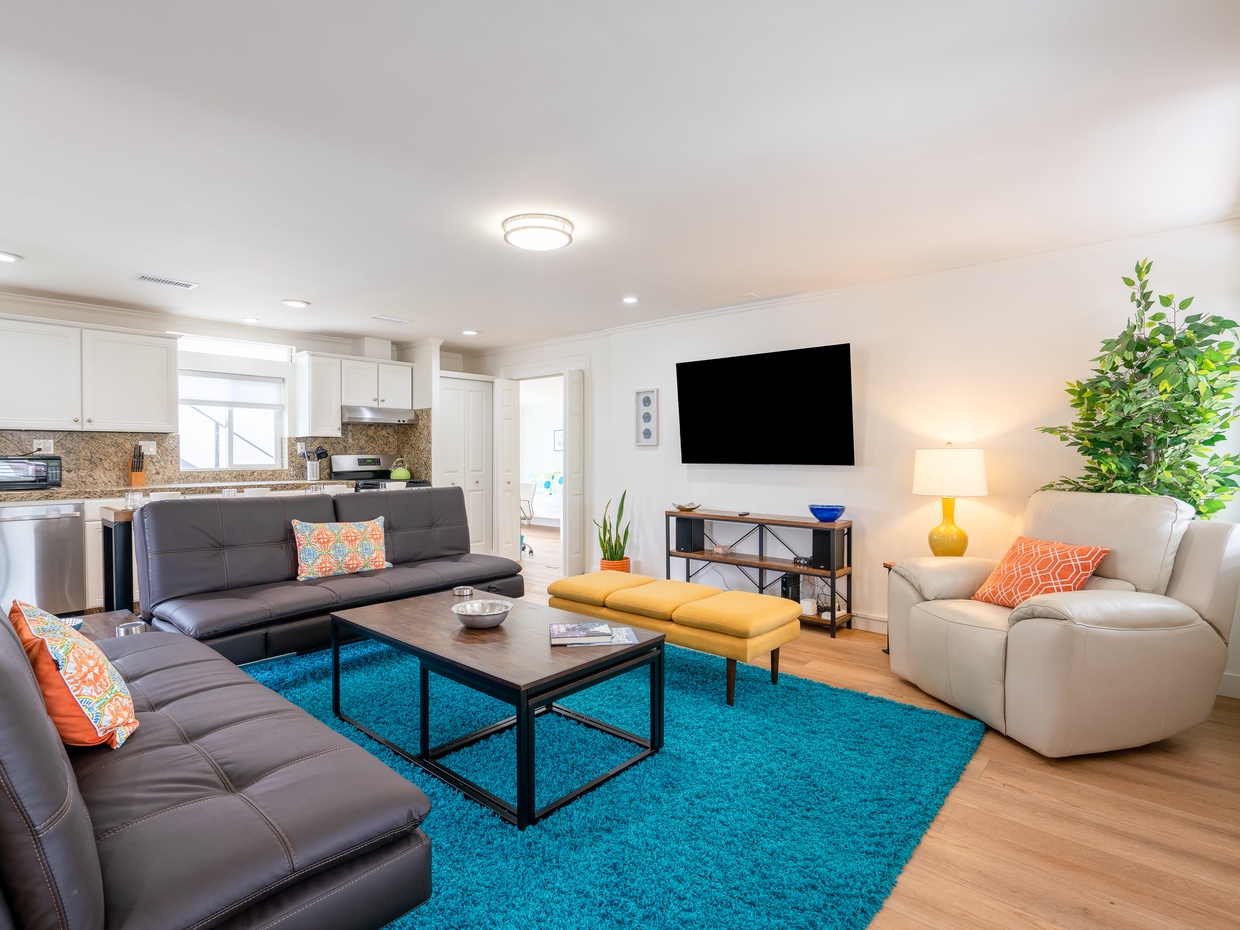 A cozy interior with plush seating and a flat screen TV. 