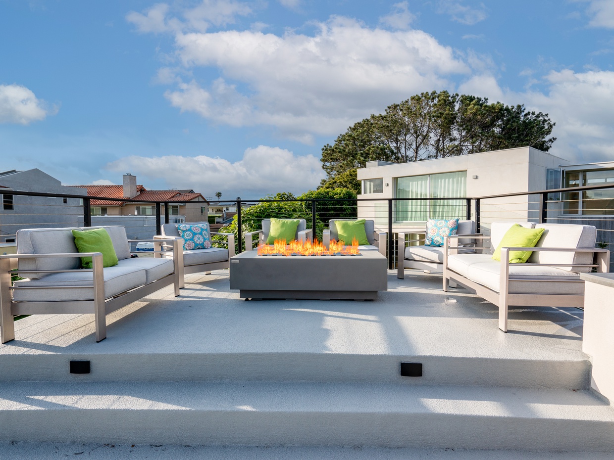 Full furnished roof top deck - seating, firepit, umbrella, and kitchenette.