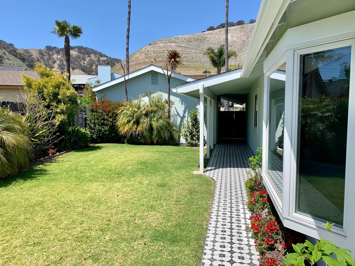 Discover the secret entrance to your retreat! A charming gate swings open to reveal the path leading to the front door. Your cozy escape awaits!