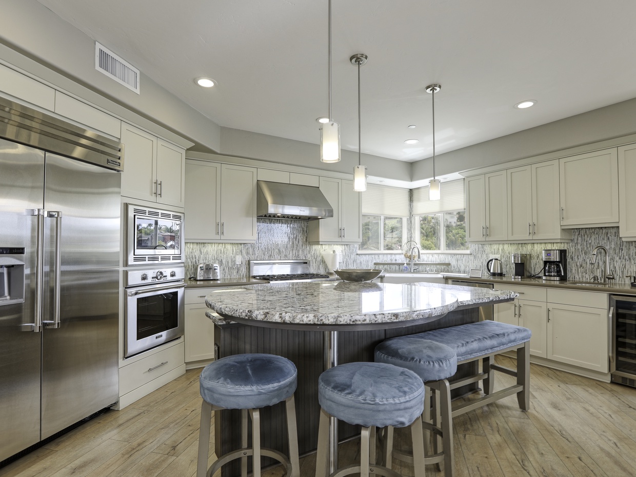 Expansive granite counter space engulf the kitchen island. Plenty of room to prep dinner while uncorking a local cab.