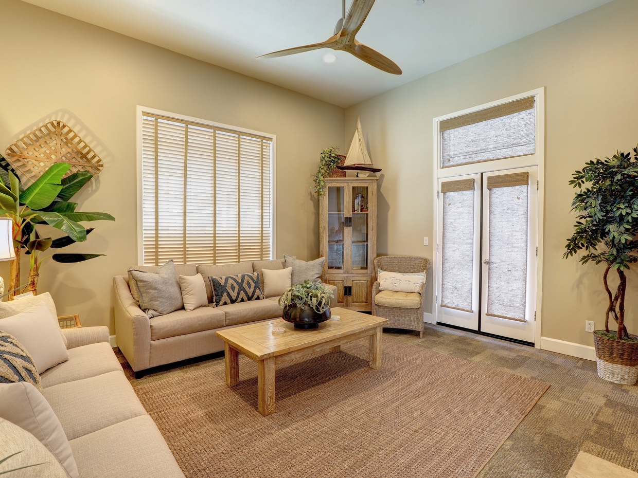 French doors open to patio. There is a glimpse of ocean view from front patio.