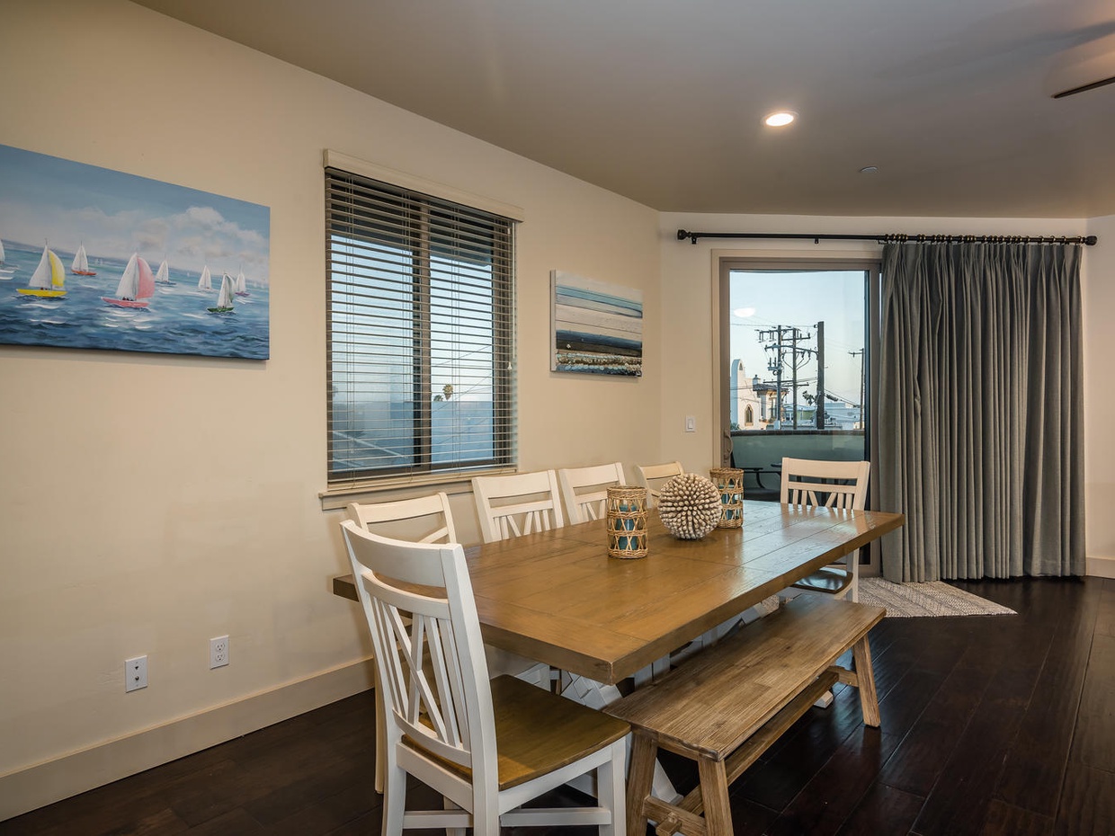Dining for 8 plus nearby bar stools at the kitchen counter.