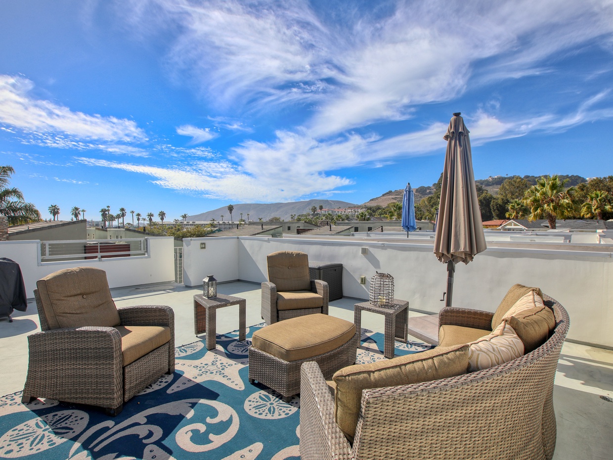 The expansive rooftop deck is the crown jewel of this modern villa condo, offering panoramic views of the sparkling Pacific Ocean and the charming town of Avila Beach.