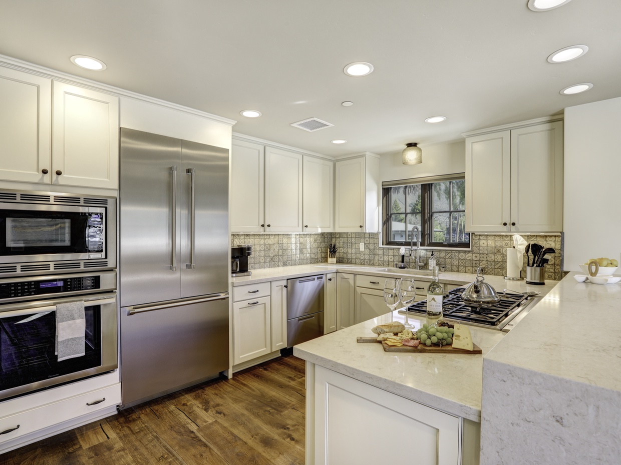 This gourmet kitchen has it all - Thermador commercial appliances, farmhouse sink, large island bar and pantry. 