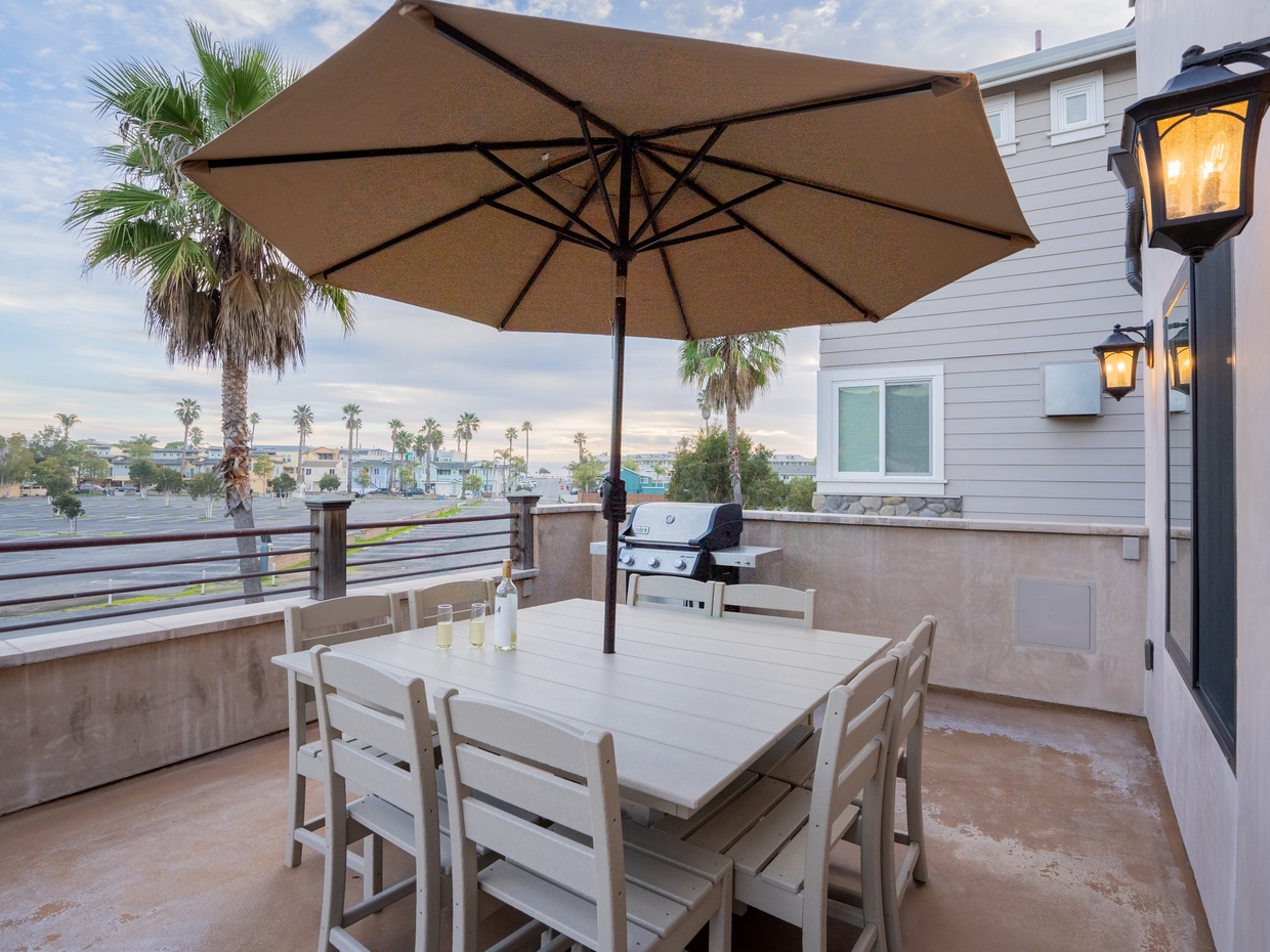 UNIT A (4Bdrm): Equipped with a barbecue grill, ample seating, and a dining table, it provides an ideal setting for al fresco dining and relaxation with scenic ocean views in the background. Outdoor living is steps from the kitchen area. 