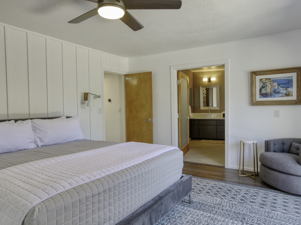 Primary ensuite has a king bed, SmartTV, and access to a private backyard.