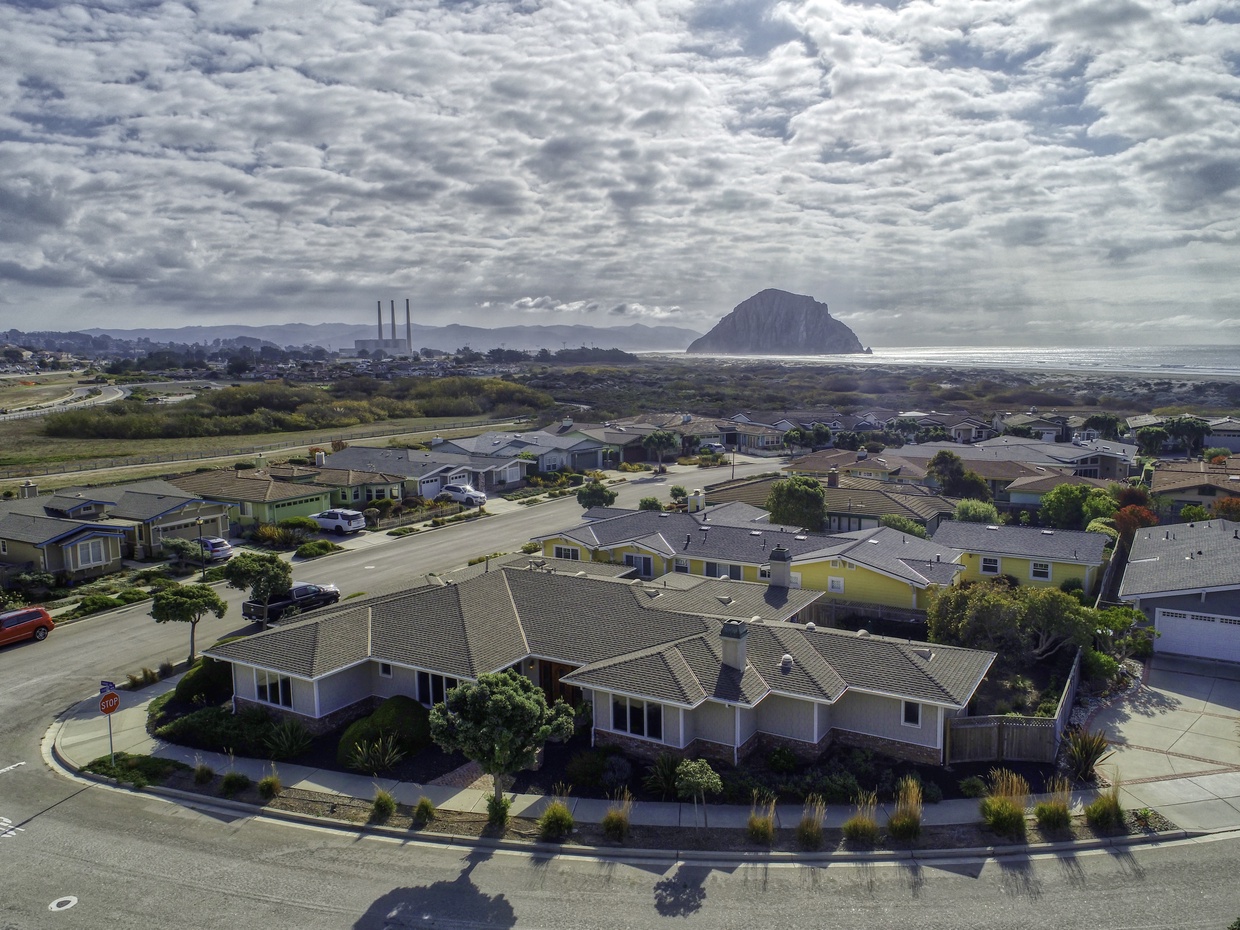 A perimeter of sandy beach and indigo blue ocean engulf this exclusive Morro Bay estate vacation home.