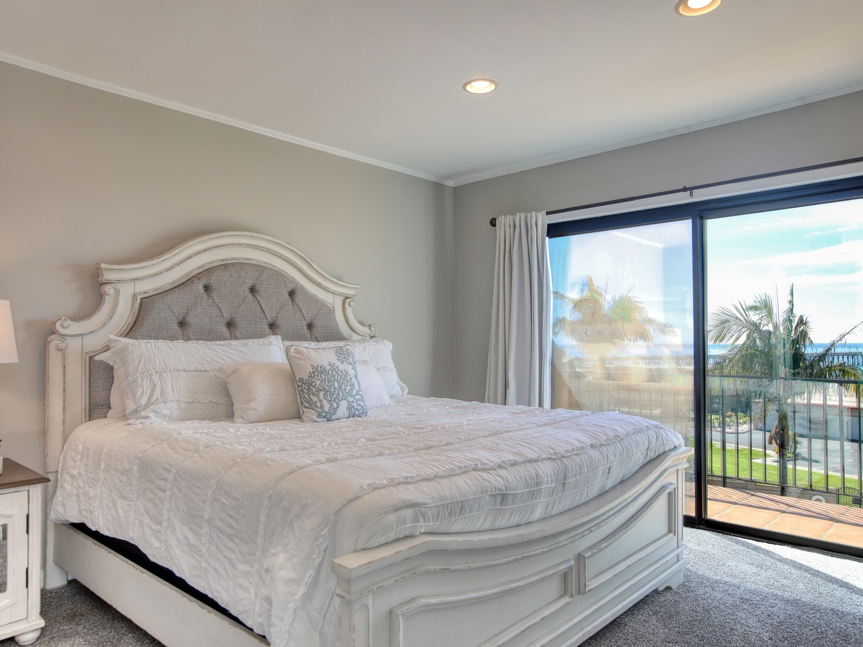 The inviting master bedroom with a beautiful view. 