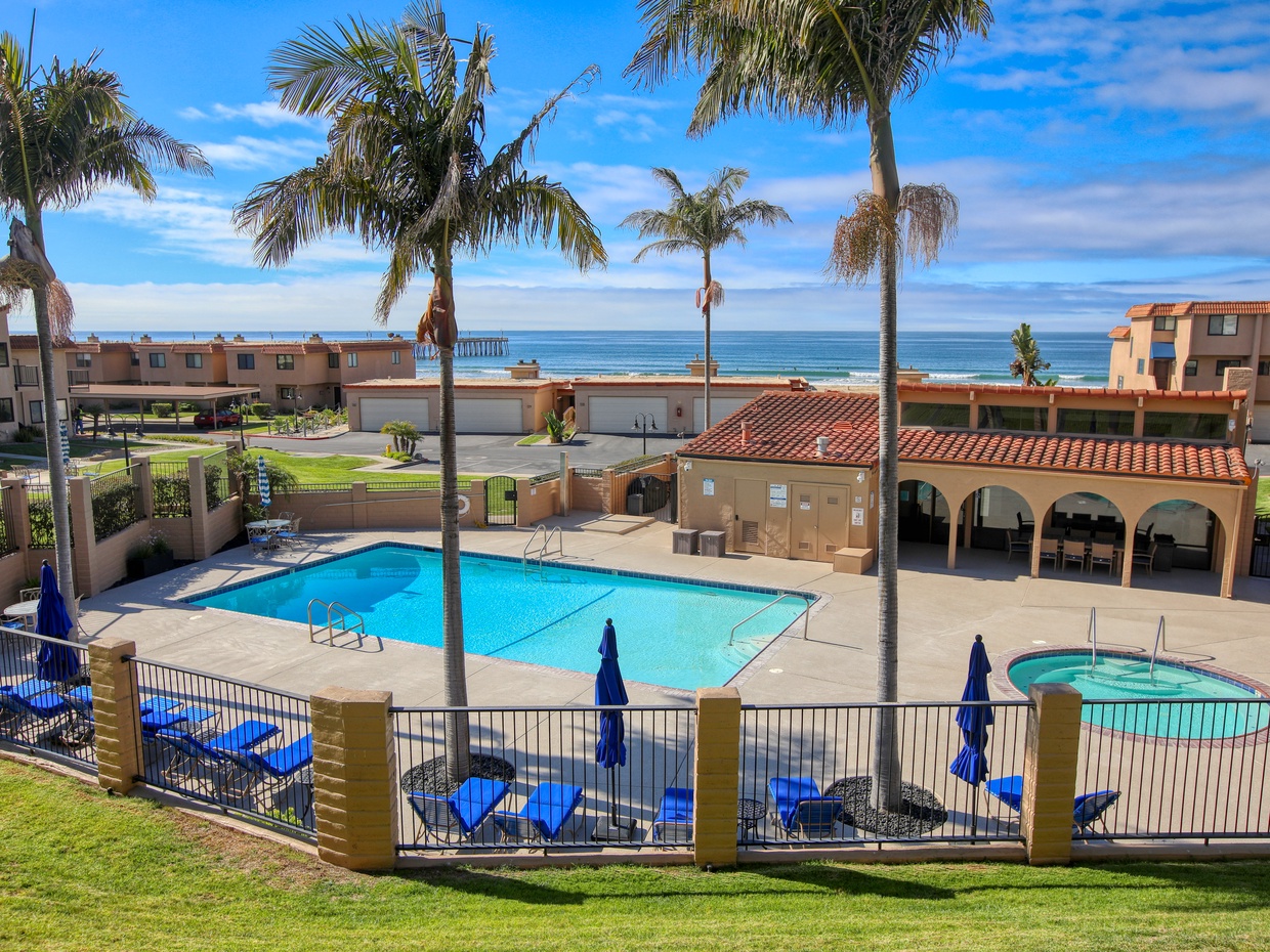 The sunny community pool is the heart of relaxation in the complex.
