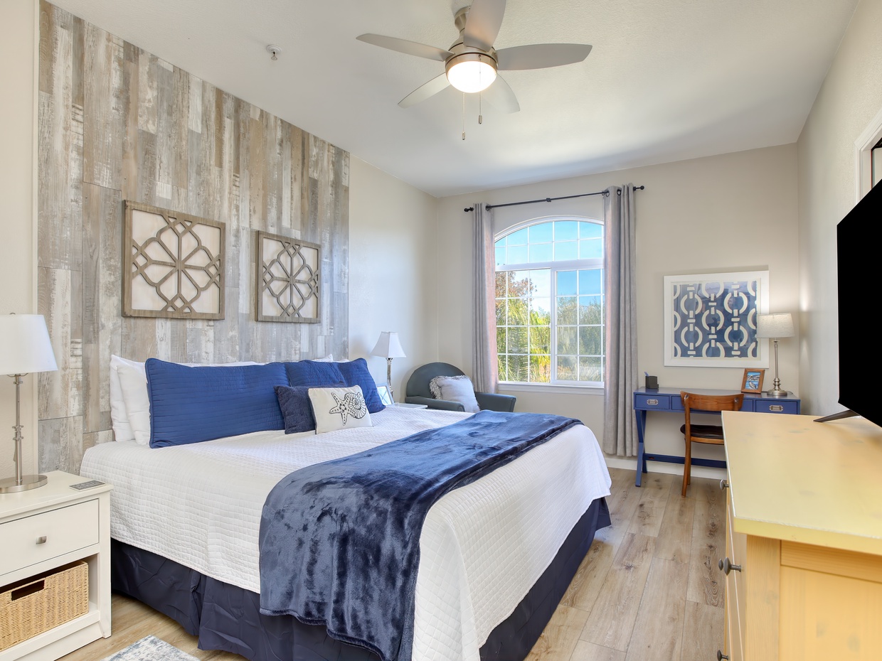 Unwind in the plush king-sized bed, dressed in crisp white linens, ensuring a restful night's sleep.