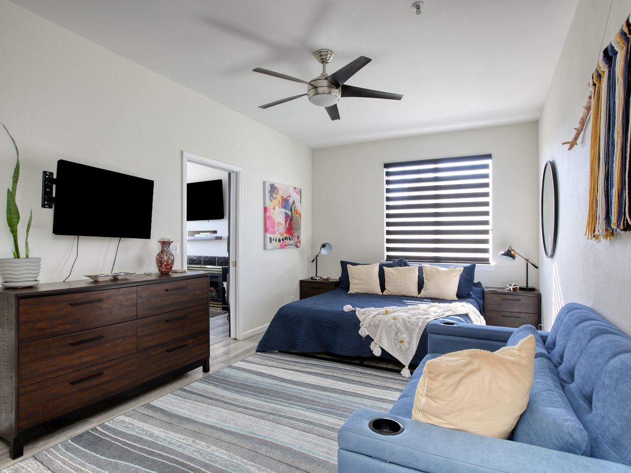 The bedroom features a comfy king bed and a queen sleeper sofa, perfect for a restful night after a day of beach adventures.
