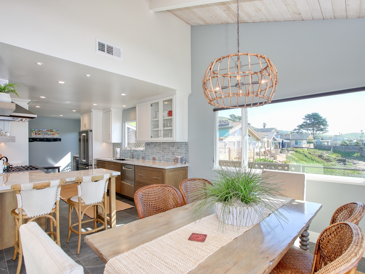 Coastal gourmet kitchen, completely remodeled in 2026 and equipped with chef-grade appliances, granite countertops, and custom cabinetry. Designed for both style and function, this bright and airy space is fully stocked with everything you need to prepare meals and entertain with ease. Pantry items not included.