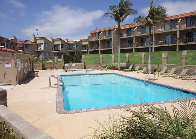 The community swimming pool and hot tub offer a relaxing coastal retreat for guests to enjoy.