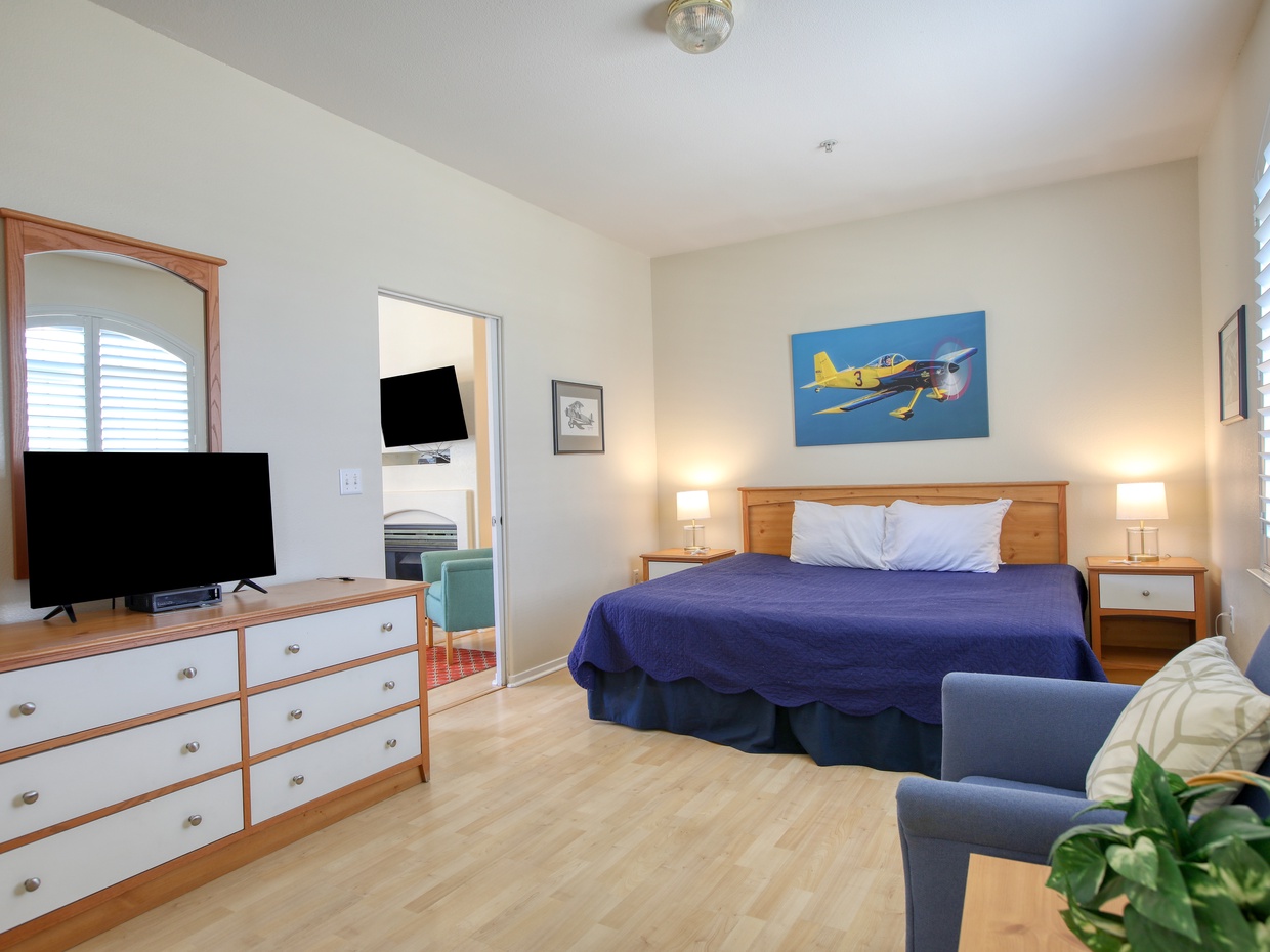 A spacious bedroom with a luxurious king bed, offering comfort and relaxation just moments from the beach.
