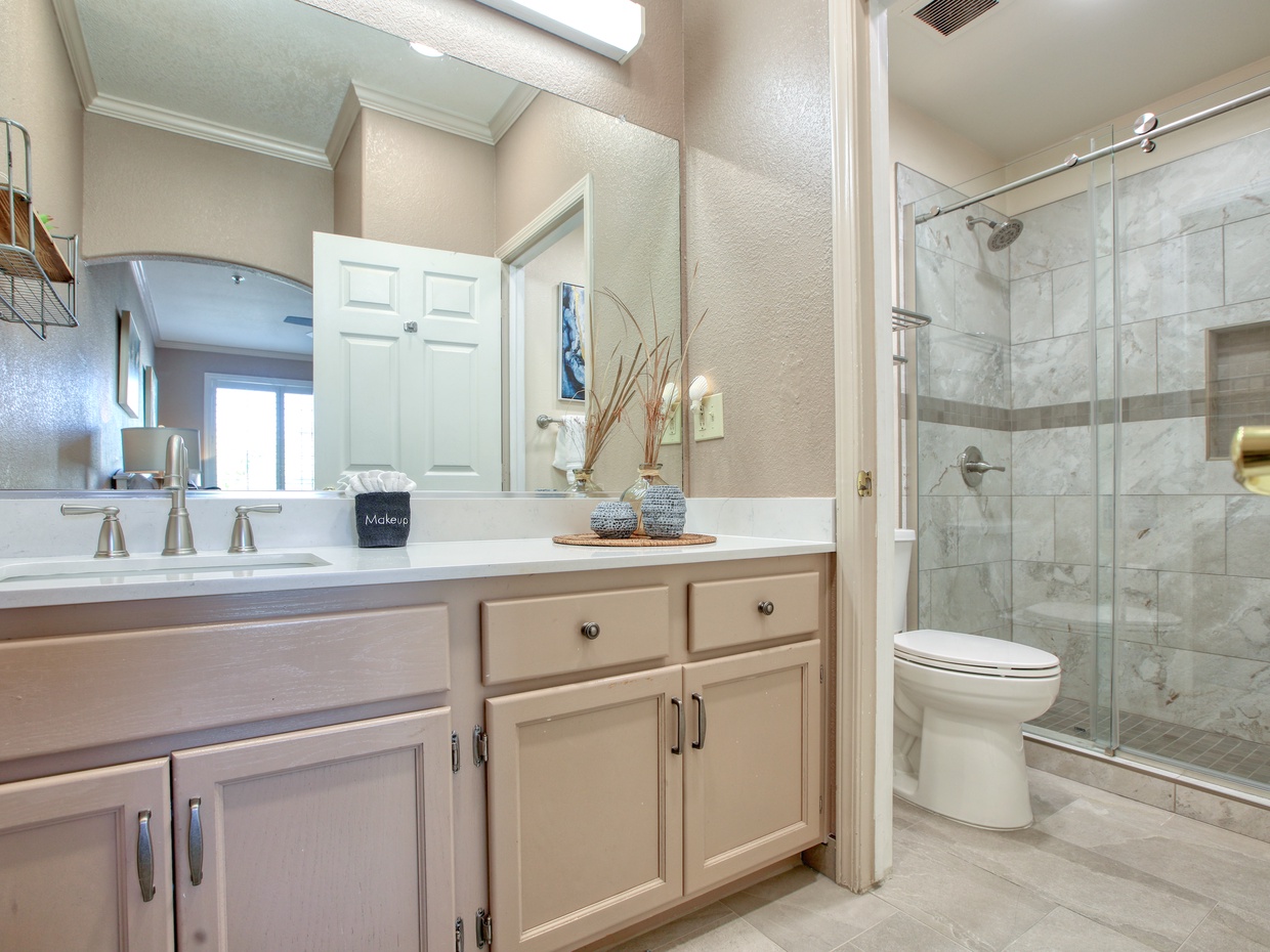 Newly remodeled bathroom! Refresh in style with our large walk-in shower and modern fixtures. The coastal-inspired design brings a calm, beachy vibe to your stay. High-quality towels and essentials included!
