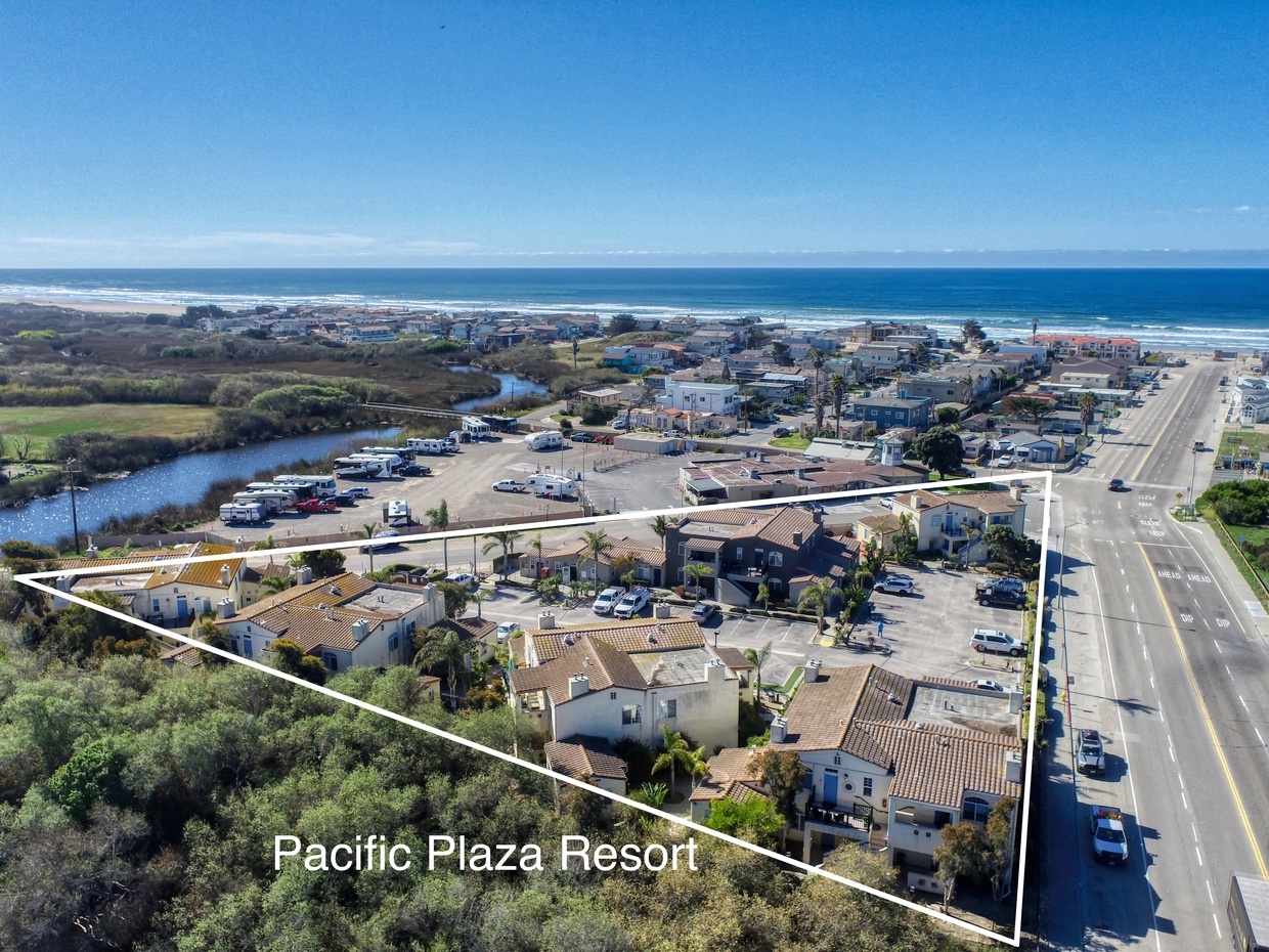 Seen from above, Pacific Plaza Resort features coastal-style buildings along Pier Avenue in Oceano, just steps from the sand and dunes of Oceano Dunes State Park.