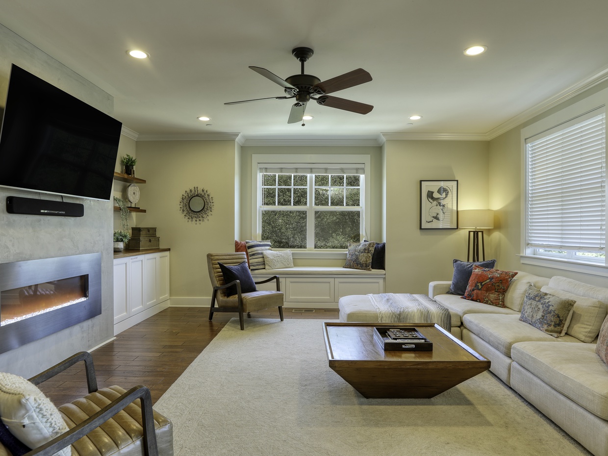 The great room is your cozy hub for relaxation! Featuring a large sectional sofa, a warming fireplace, and a big flat-screen TV—perfect for movie nights or winding down.
