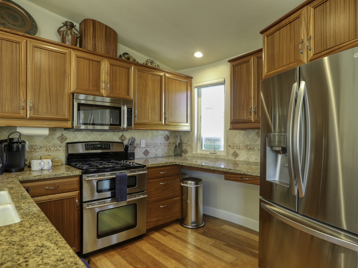 Stainless steel kitchen appliances.  Kitchen area extends into great room.