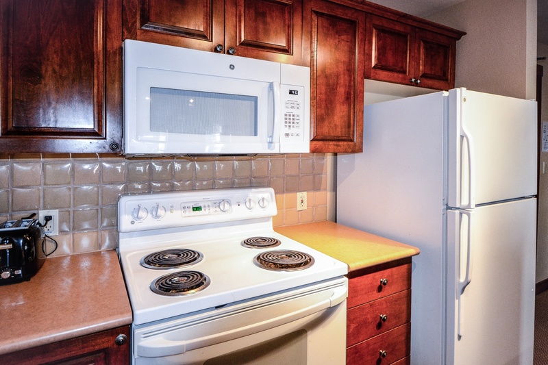 Kitchen with Electric Stove, Drip Coffee Maker, Microwave